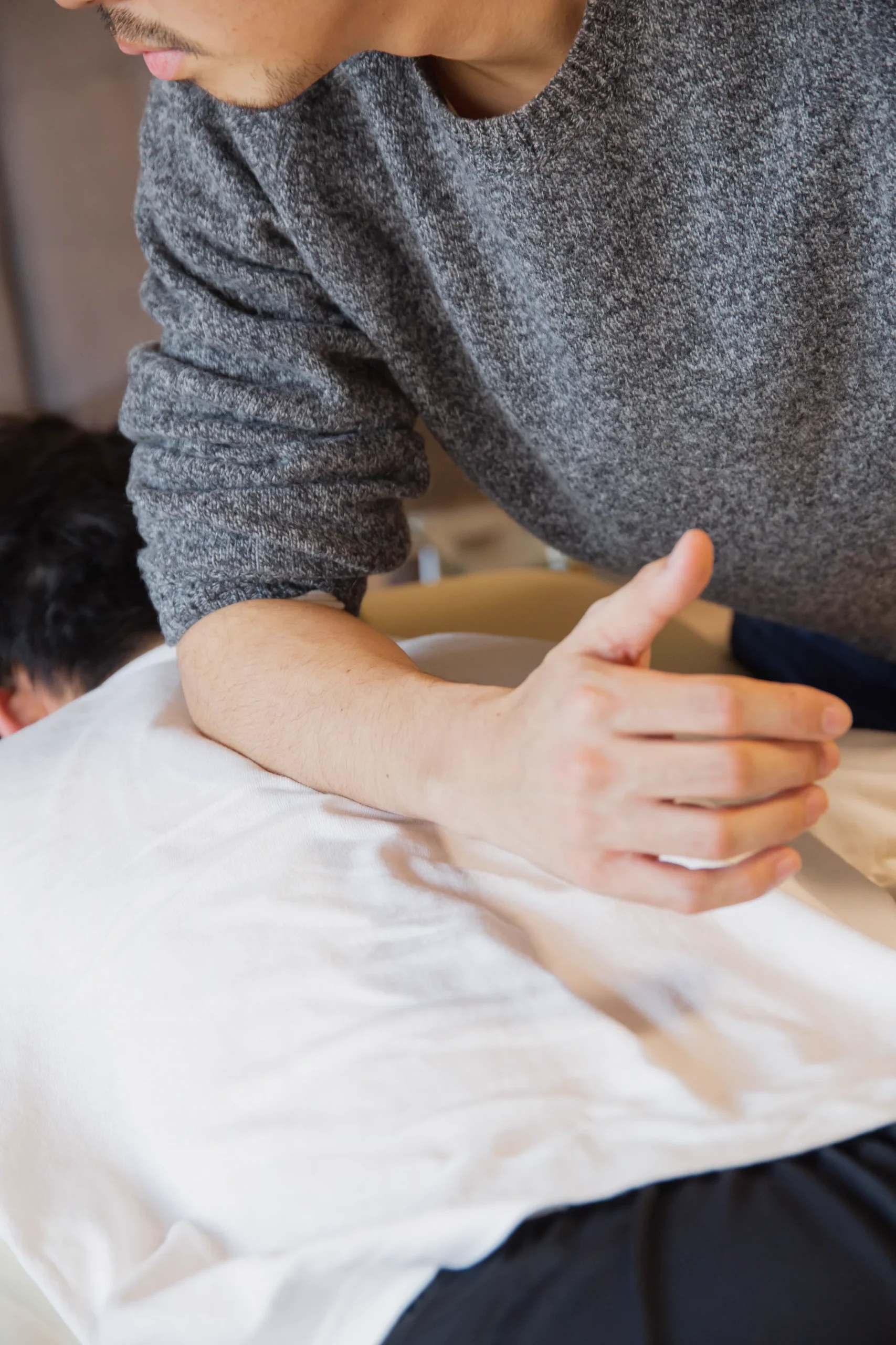 Massage therapist providing hands-on back care