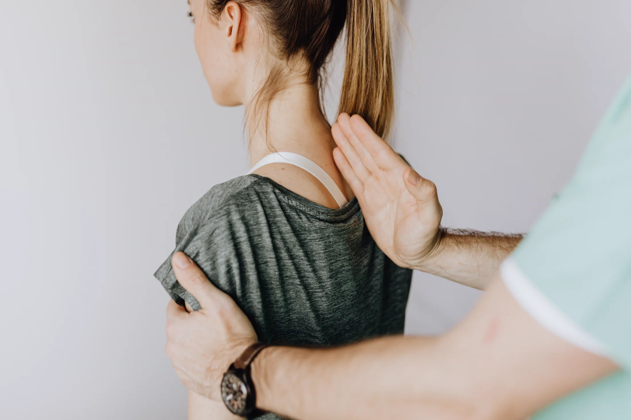 Practitioner evaluating a patient’s spinal posture