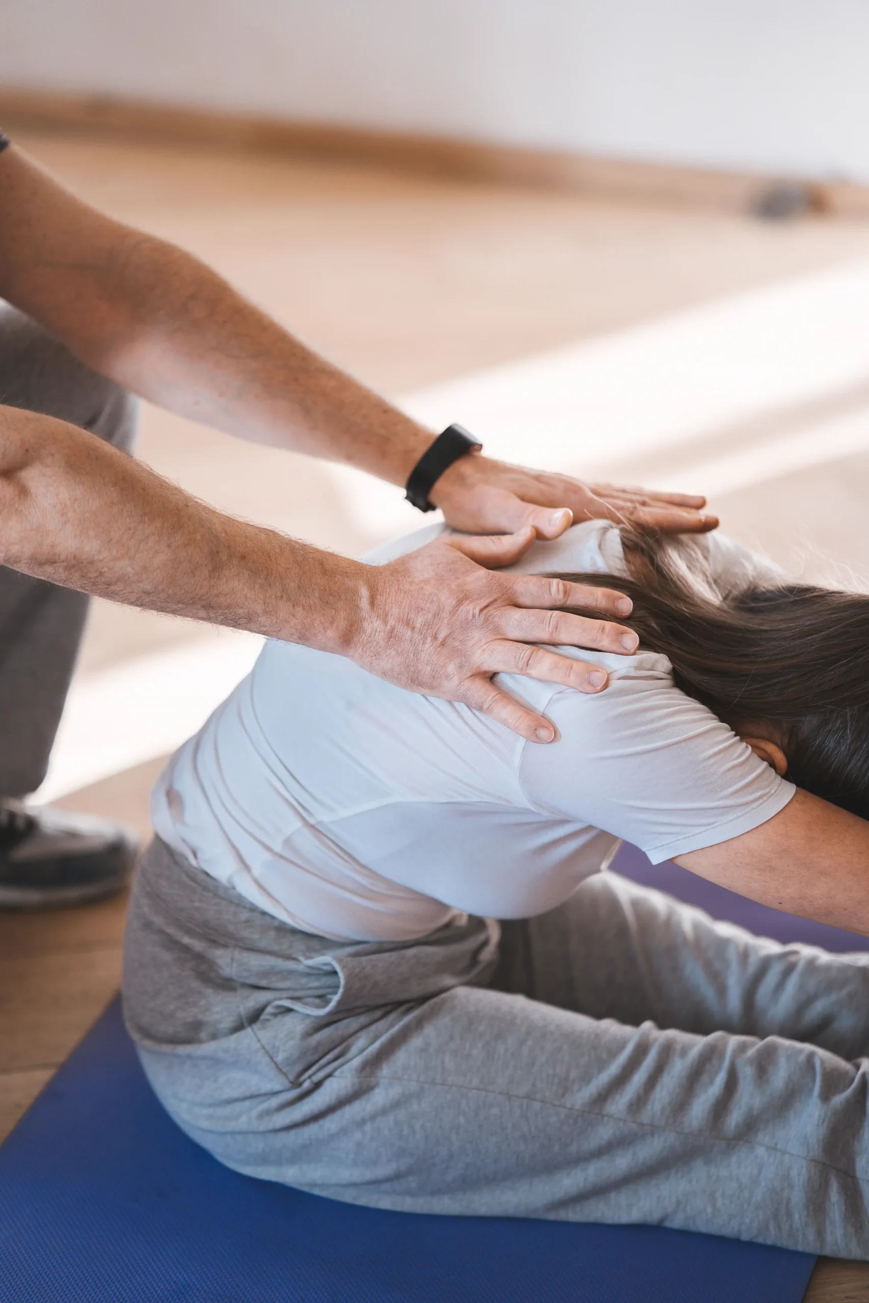 Practitioner assisting a patient with a guided stretch